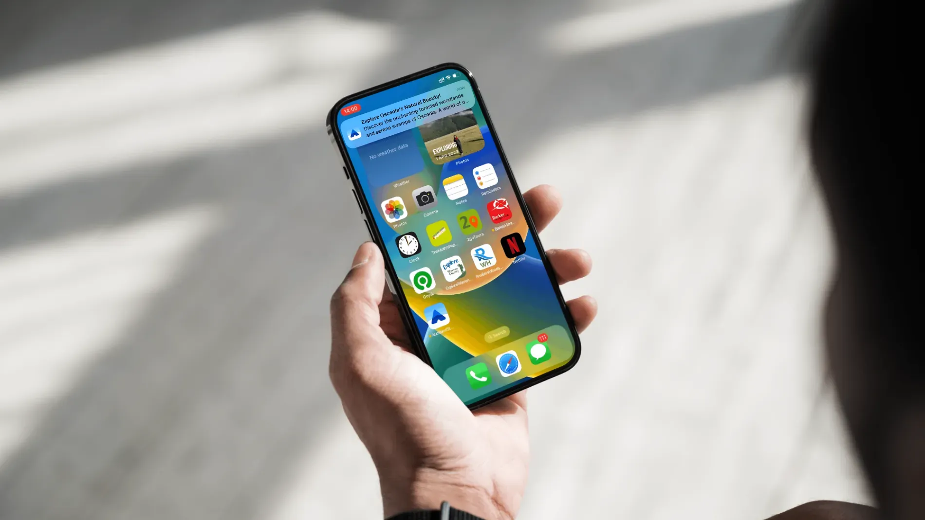 Person holding smartphone displaying a push notification from a visitor experience app.