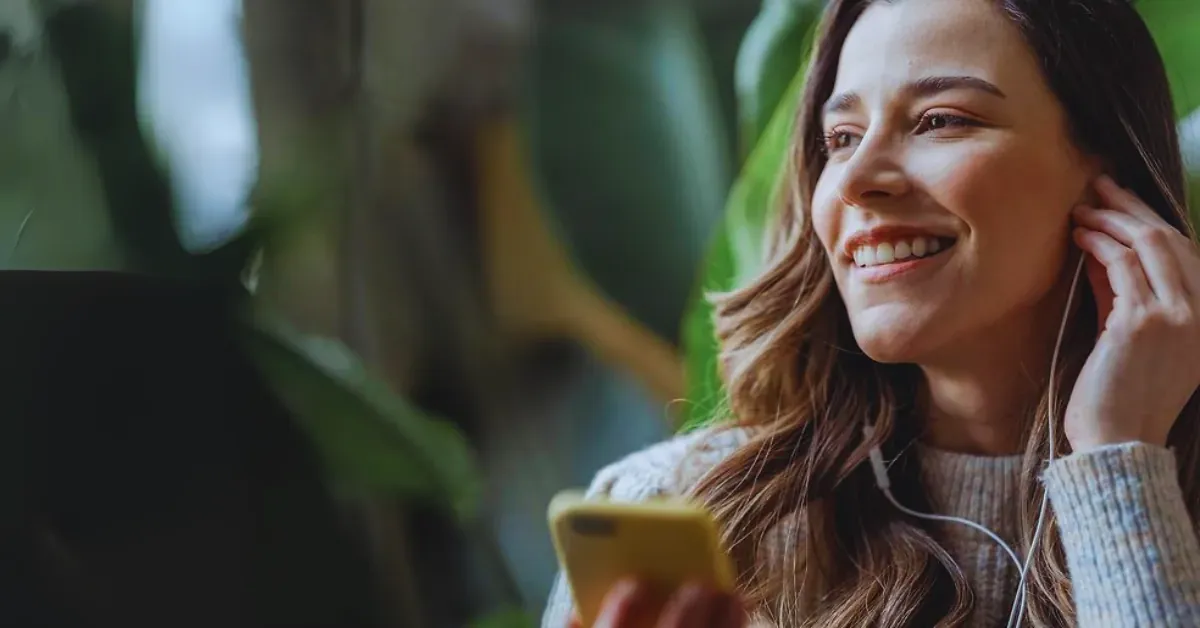 Girl on phone listening to audio guide.