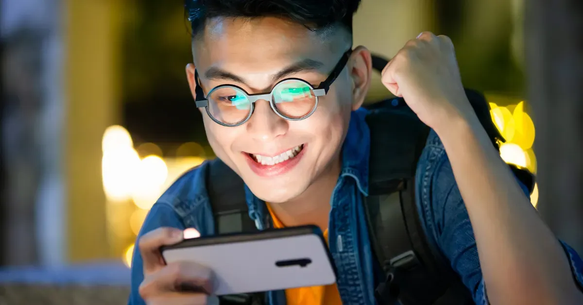 A happy tourist enjoying a gamified experience on their smartphone while exploring.