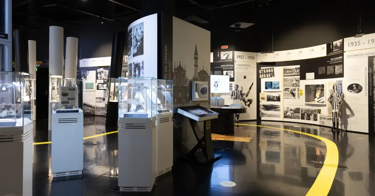 Museum wayfinding yellow floor stripe leading visitors through a sports history exhibition.