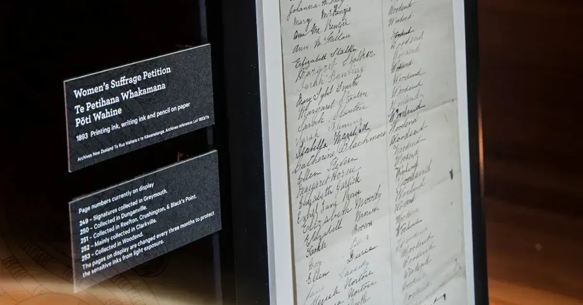 A historical document stop on a self-guided tour showcasing the original Women’s Suffrage Petition signatures in a gallery.